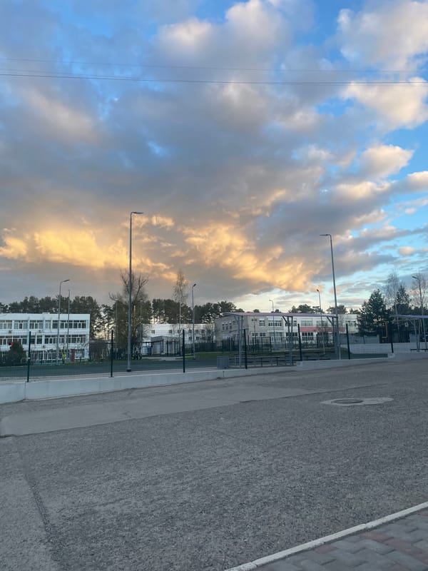 Roadside landscape captured showing dramatic sky over urban area
