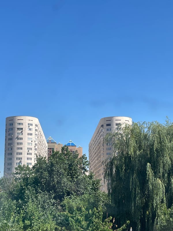 Residential buildings in Almaty under clear blue sky
