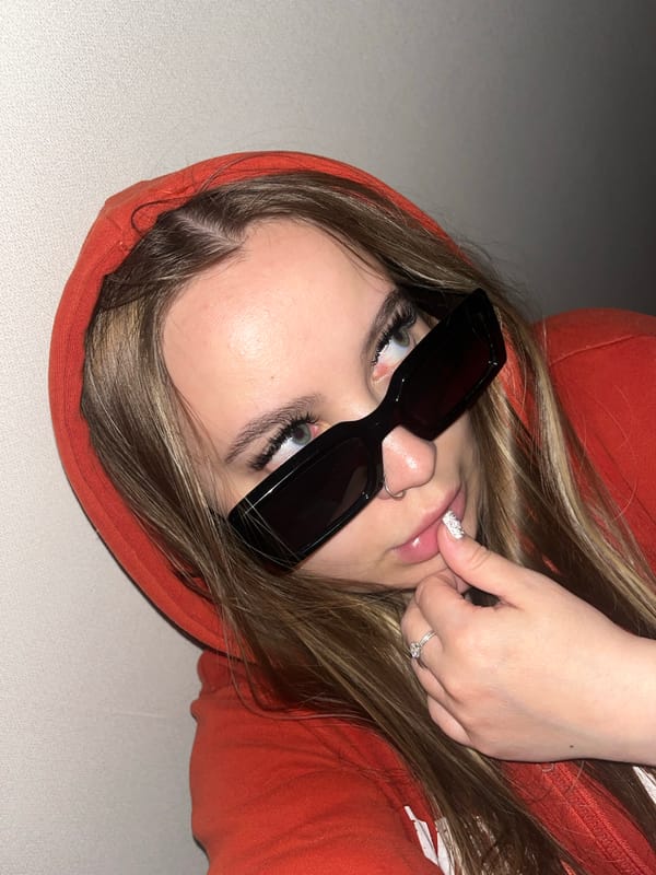 Person in orange hoodie photographed relaxing indoors in Krasnodar