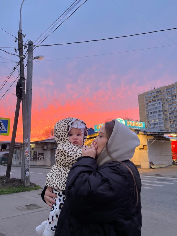 Woman and baby share tender moment during Krasnodar sunset