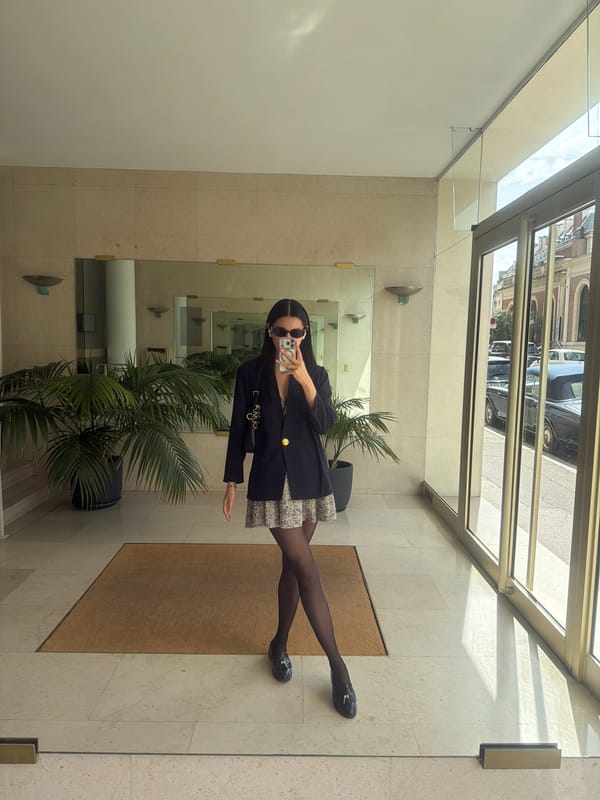 Woman takes selfie in stone building in Paris