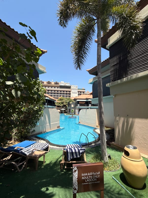 Tourist documents sunny morning walk through Dubai resort complex