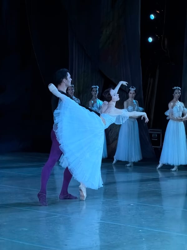 Ballet performance unfolds on a blue-lit stage in Ufa