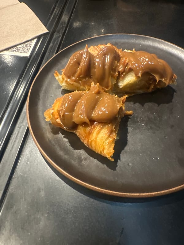 Croissant meal with brown sauce documented at unknown location