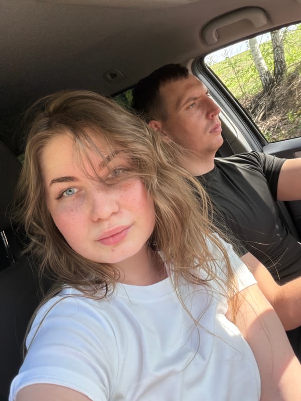 Two people take selfie in vehicle in Ural'skoe, Russia