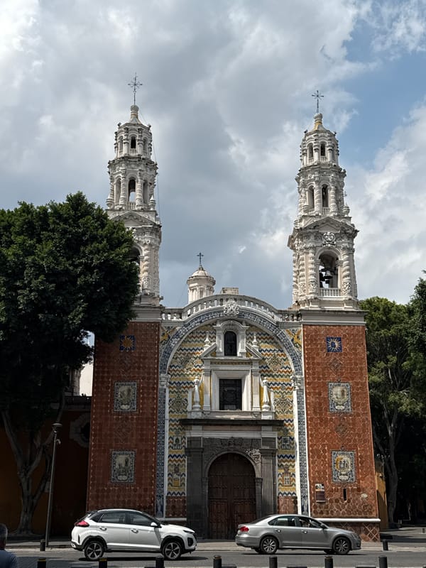 Tourist documents historic Puebla church and monuments during evening visit