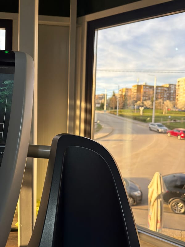 Window view captures everyday Pernik cityscape from indoor location