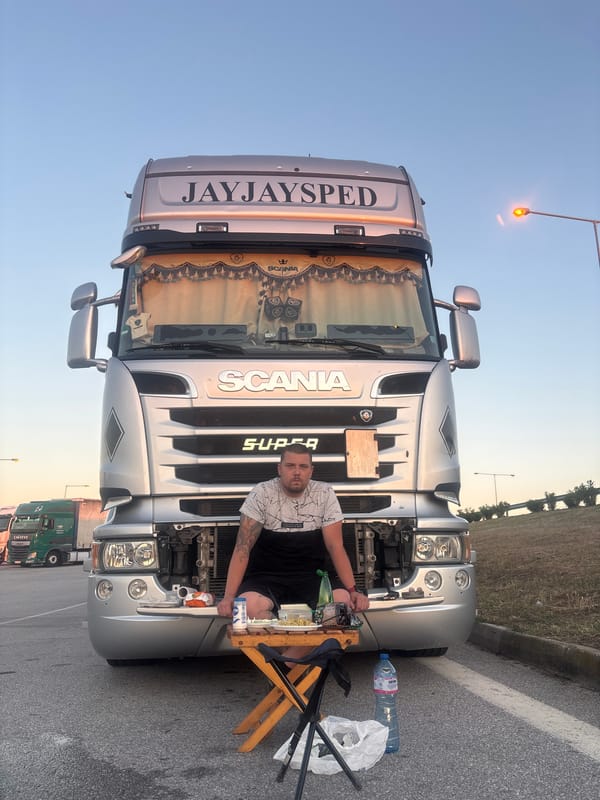 Evening trucking stop with commercial vehicles and meal break