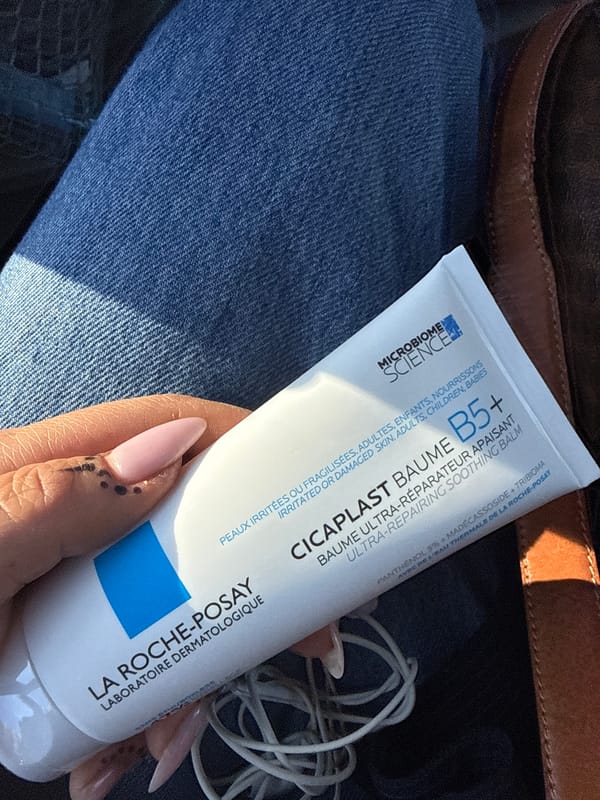 Person holds skincare product in Oslo