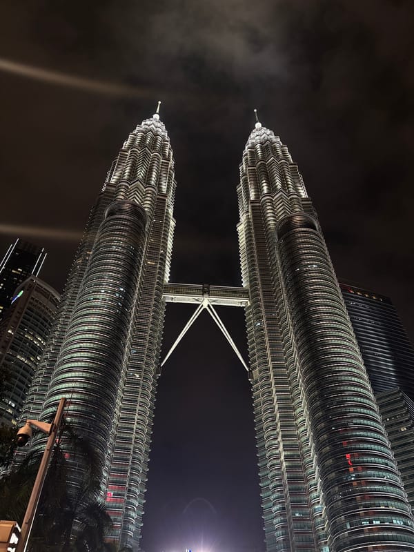 Night photography session captures illuminated Petronas Twin Towers in Kuala Lumpur