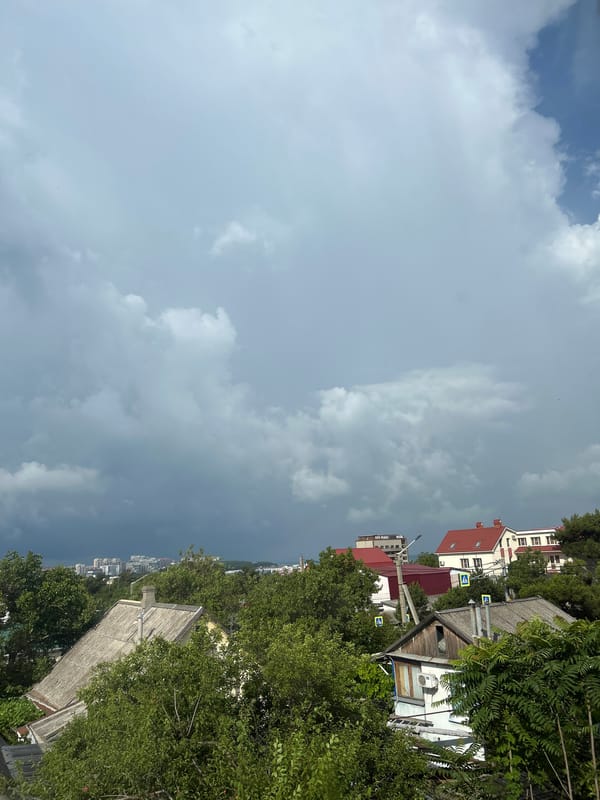 Storm clouds gather over Gelendzhik as life continues indoors