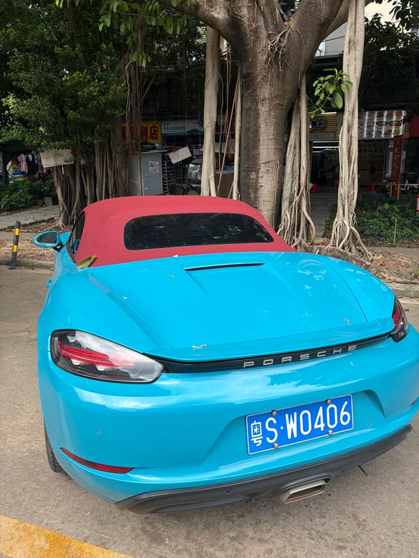 Blue Porsche convertible parked in Panyu District, China
