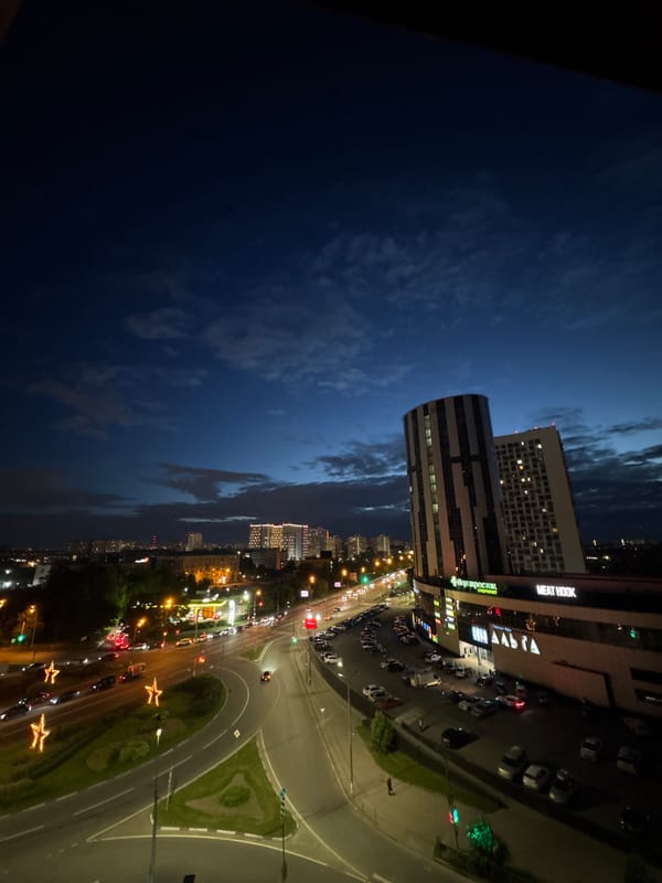 Pushkino at dusk: intersections, apartment blocks, and nightfall