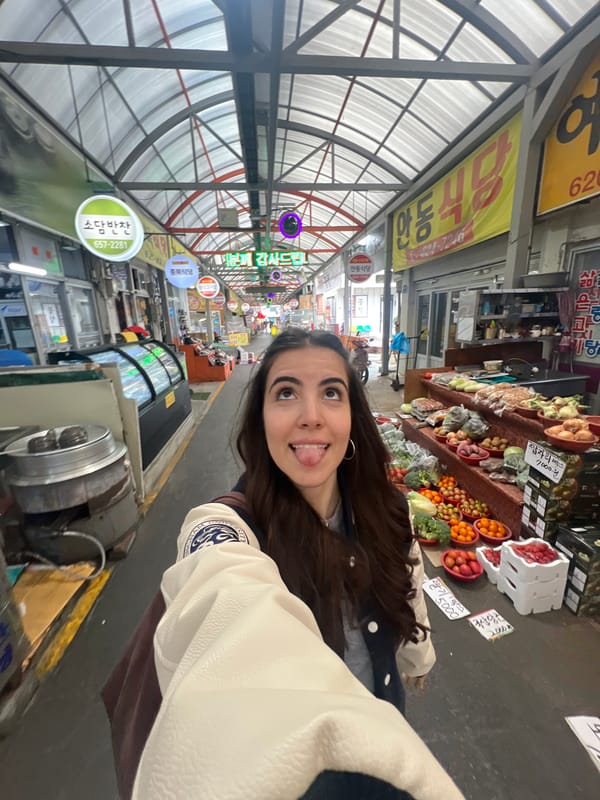 Woman takes selfie in traditional Daegu market
