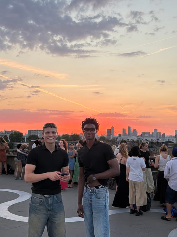 London rooftop crowd watches a vivid summer sunset unfold