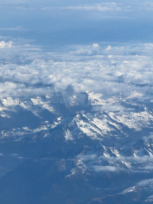 Aerial view captures snow-capped Dolomites peaks in clear skies
