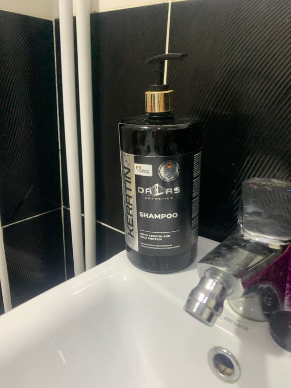 Personal items around a home desk and bathroom in Glodeni