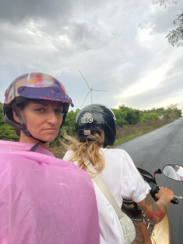 Two women visit Mui Ne wind farms by motorcycle