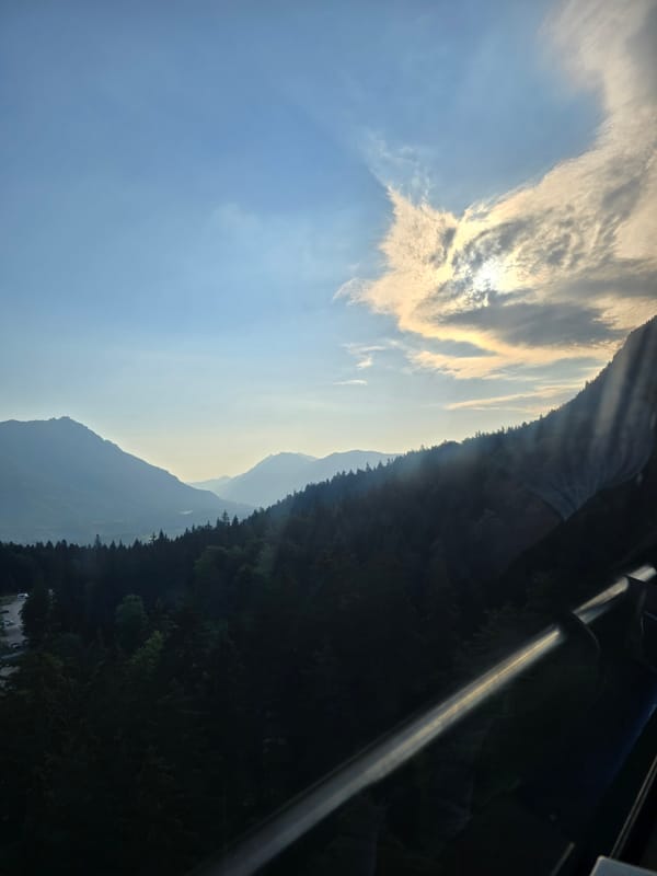 Zugspitze cable car towers and misty Alpine peaks, early morning