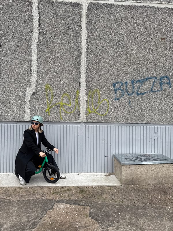 Woman with green bicycle spotted in Riga street scene