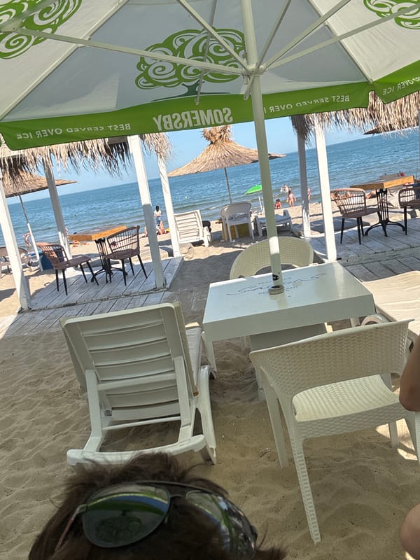 Busy afternoon at Varna beach resort with sunbathers and cafes