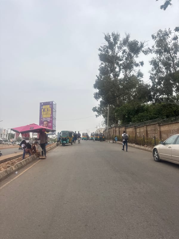 Street scene documented in Jos, Nigeria under overcast skies