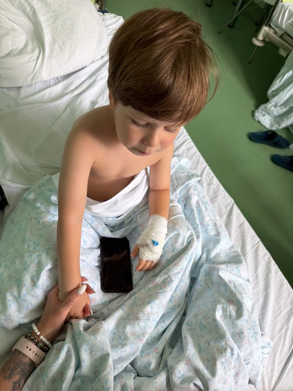 Resting in a Moscow hospital room, bandage visible on arm