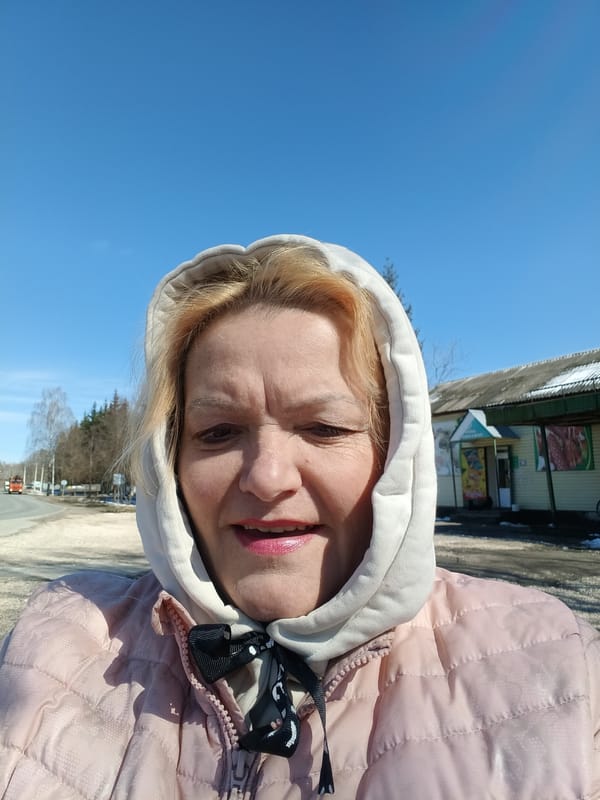 Woman and dogs spotted in spring park scene in Красный Маяк