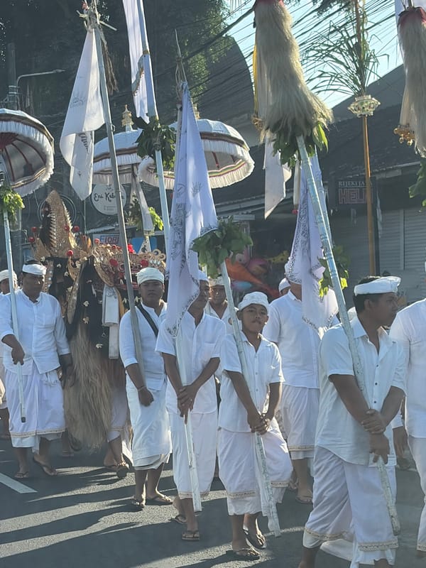 Traditional procession with flags and ceremonial dress in Abiansemal
