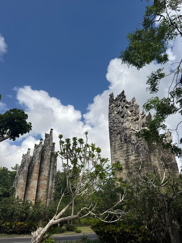 Tourist documents morning walk through ornate Kuta Selatan cultural site