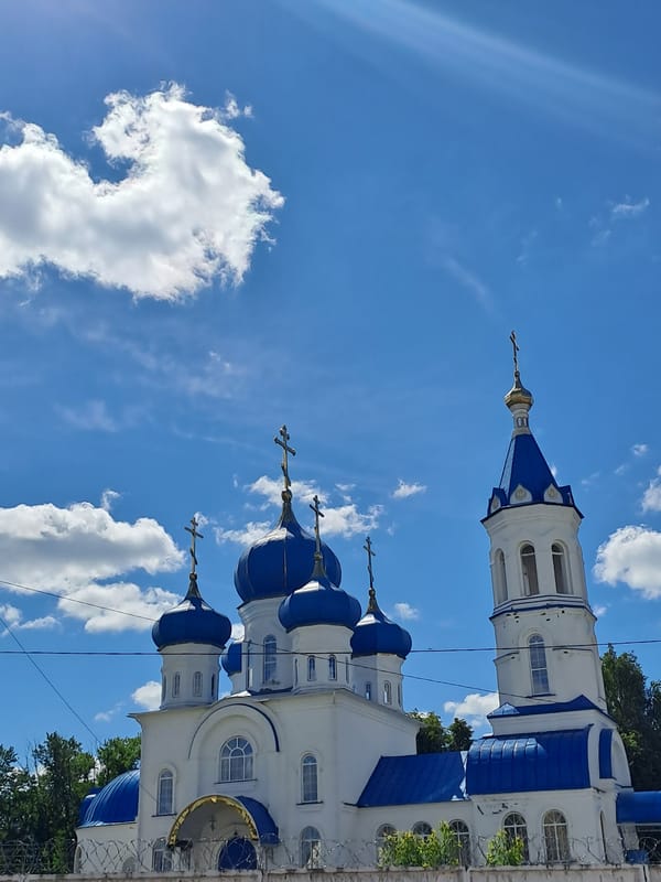 Orthodox church, commercial truck observed in Yalga, Russia morning