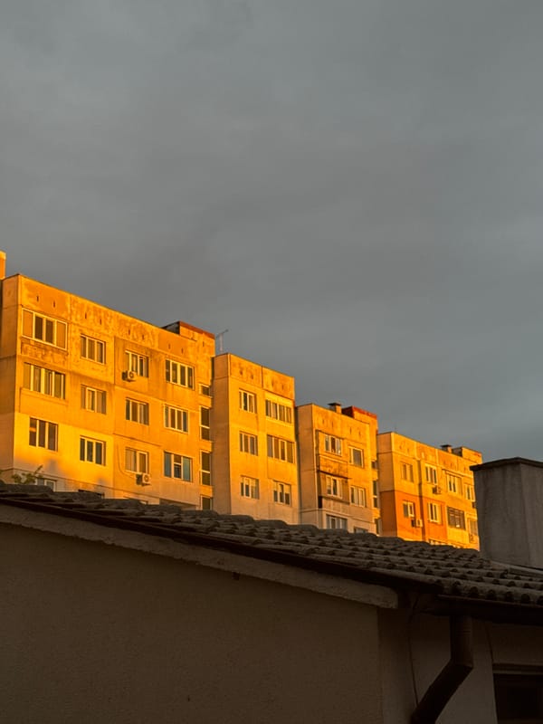 Urban high-rises with golden lighting observed under overcast skies