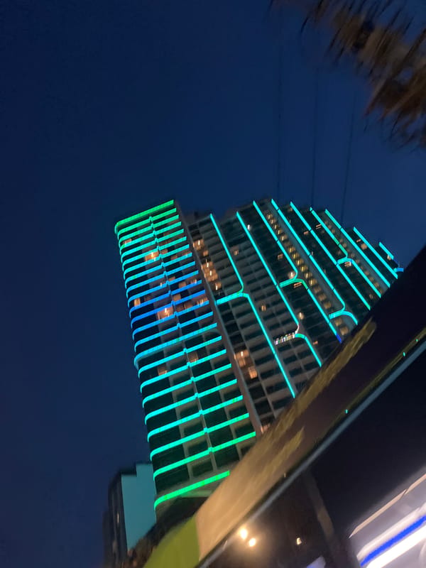 Nha Trang's neon-lit skyline and beach at night