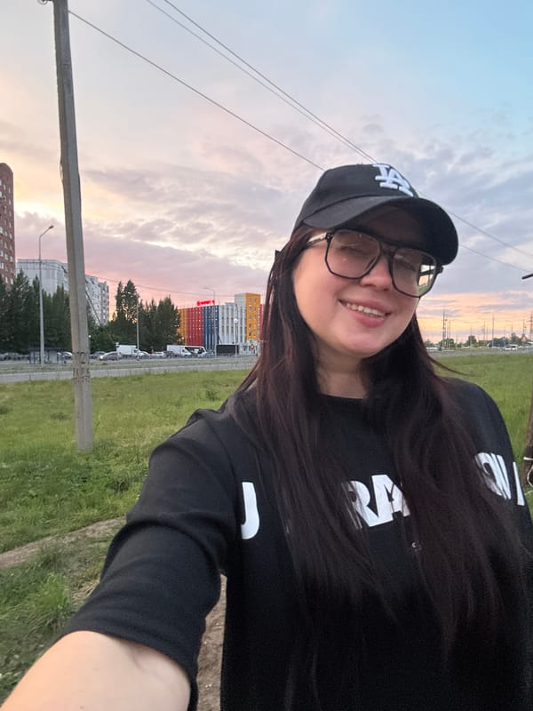 Woman documents colorful urban sunset with husky companion