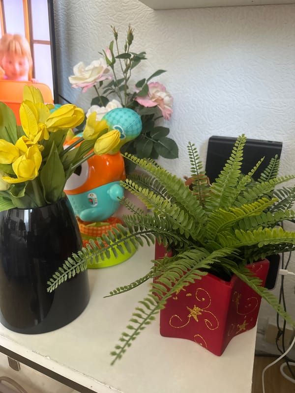 Home display with artificial flowers and baby toys documented Strasbourg