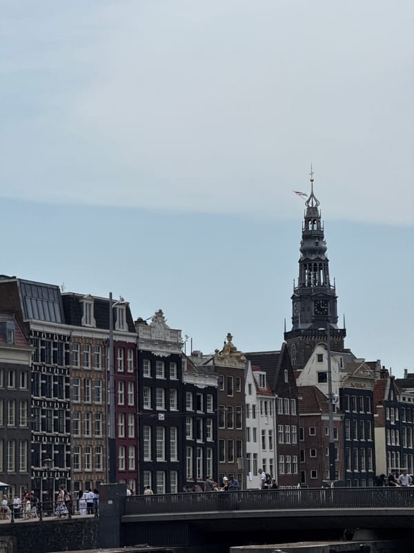 Canals, barges, and the basilica near Amsterdam Centraal