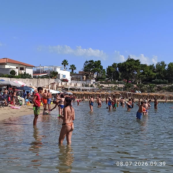Crowded summer beach day on the Adriatic coast in Trani