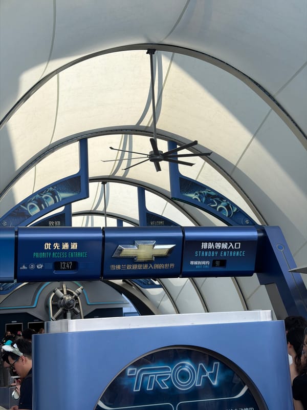 Tourists pose for photos at Shanghai Disneyland attractions
