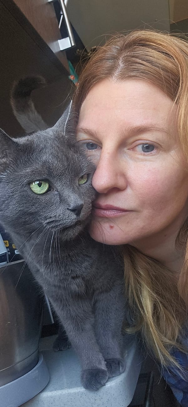 Woman Takes Morning Selfie With Grey Cat