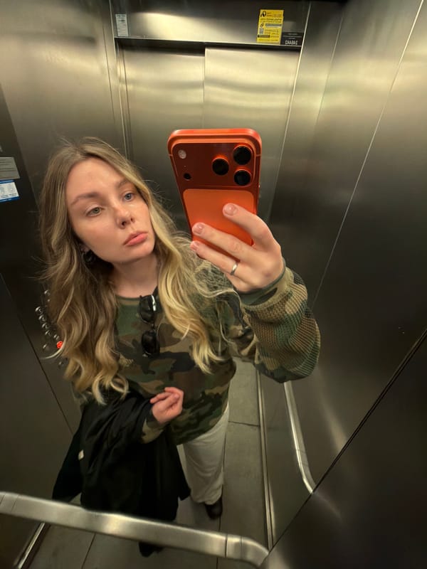 Coca-Cola truck parked on Tel Aviv sidewalk near flagged lamppost