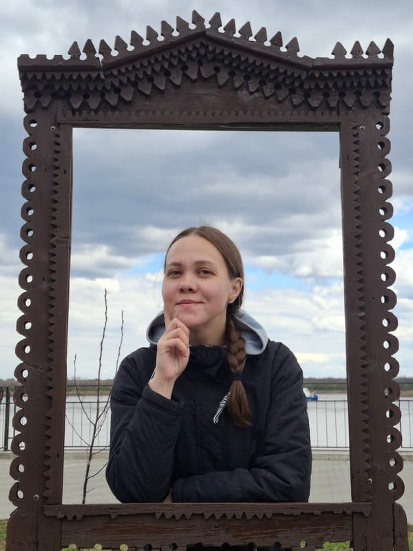 Tourist photographs young woman at Sarapul landmarks during morning visit