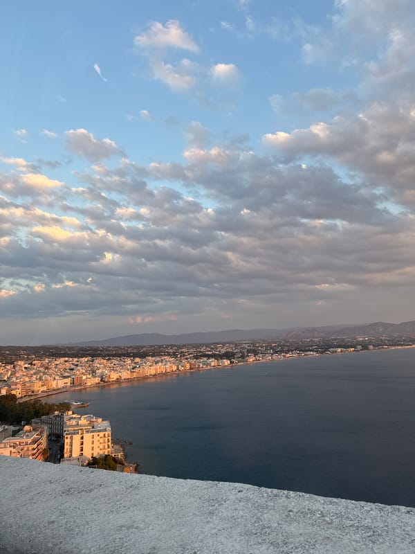 Calm seas, two moods: overcast swimmers and a sunset coastline