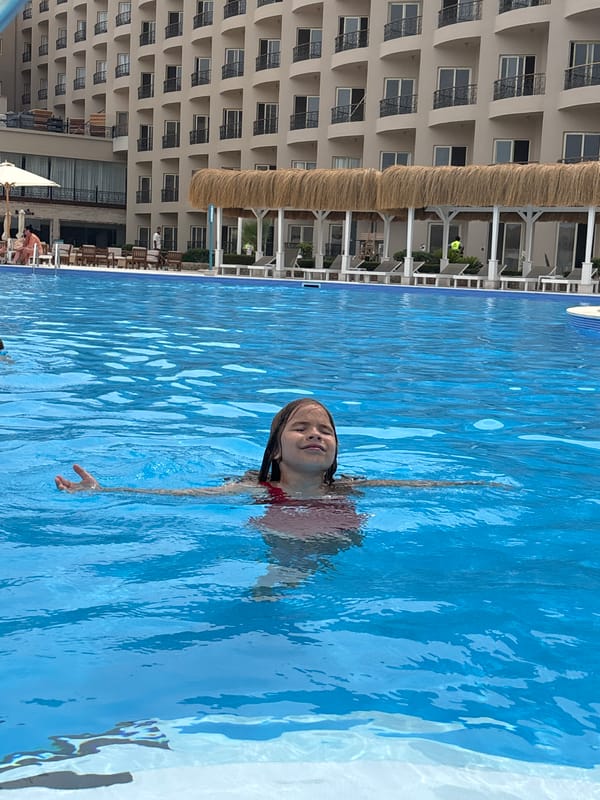 Child floats in hotel pool in Al Ahia', Egypt