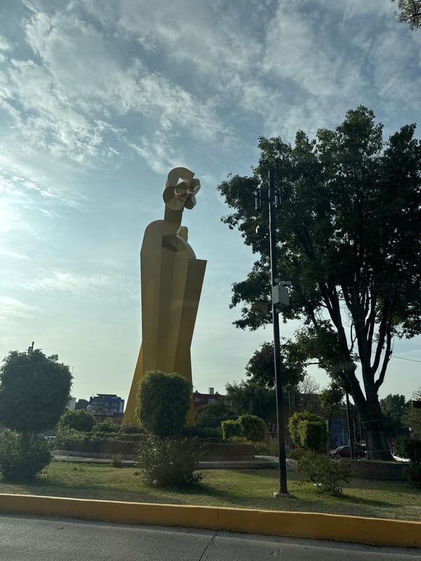 Street scenes and yellow sculpture documented in Puebla