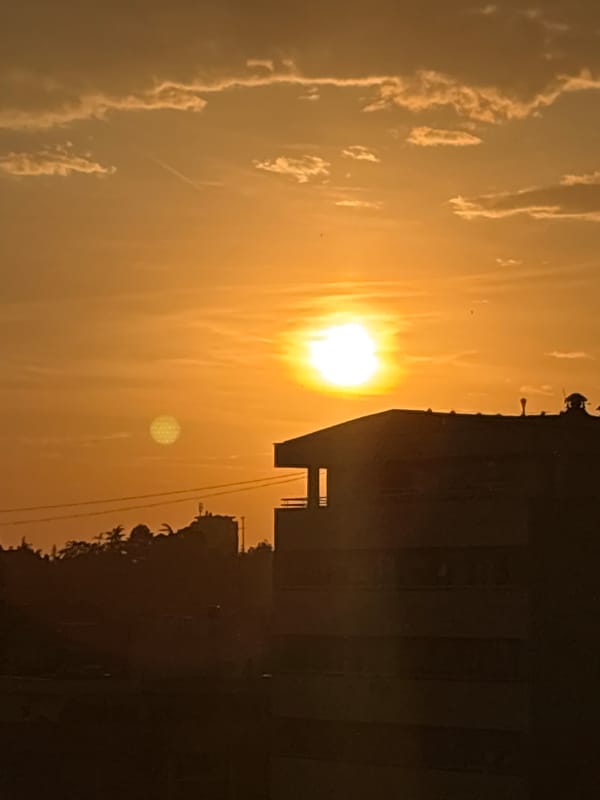 Sunset observed across Belgrade cityscape during evening hours
