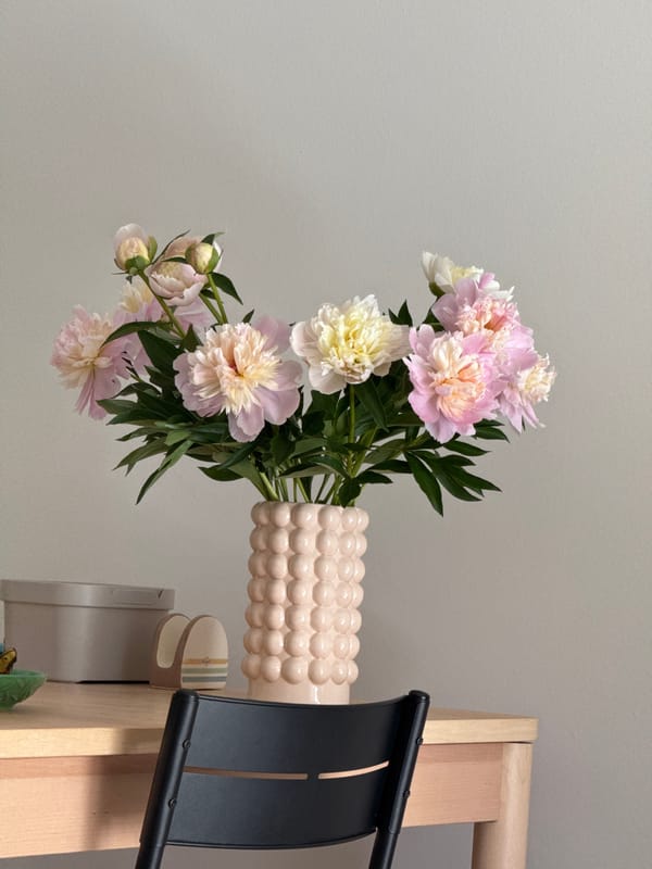 Peonies and a nautical desk calendar on a Russian tabletop