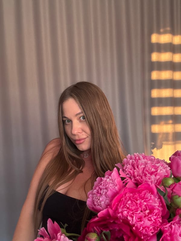 Woman poses with pink peonies in Chernushka photo session