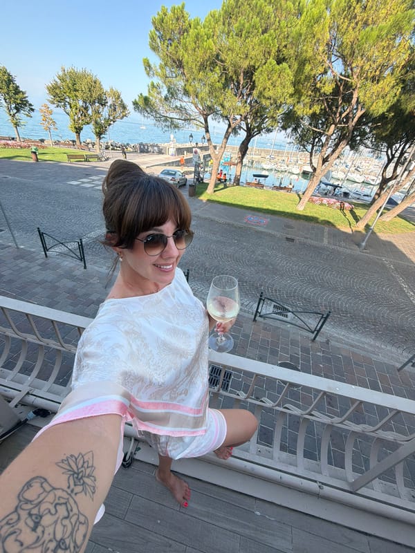 Selfies on a balcony above Desenzano del Garda's harbor