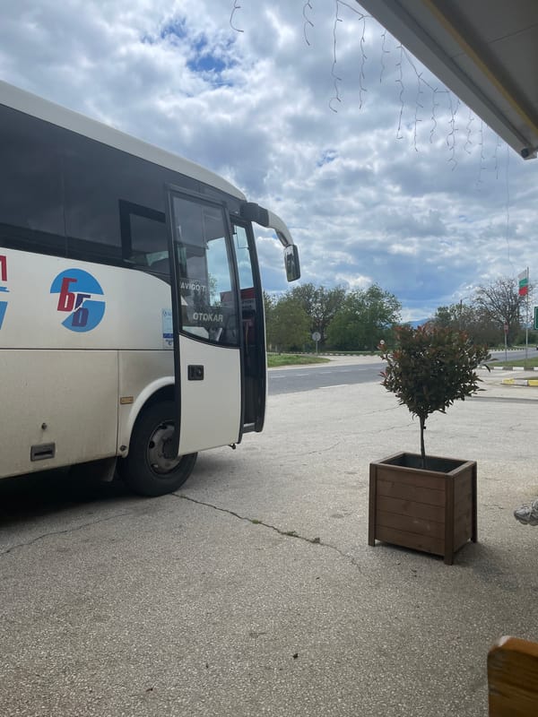 Bus parks near restaurant in Bulgarian town square