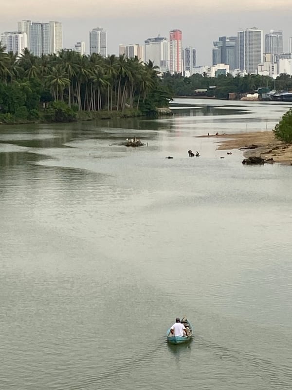 Nha Trang river views with city skyline on a cloudy morning